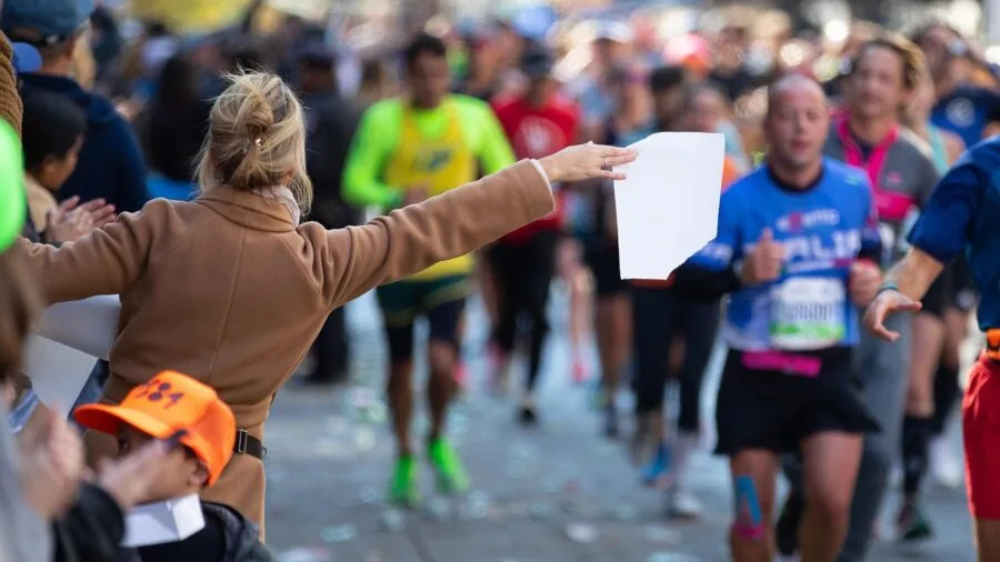Close-up of athlete checking compression sock fit on foot during outdoor run preparation