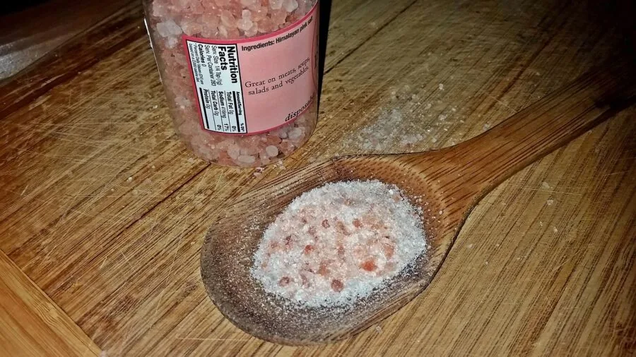 Close-up of authentic pink Himalayan salt crystals showing natural mineral formations and warm orange tones