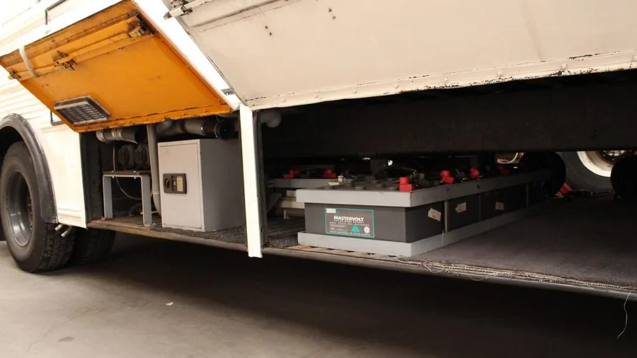 Close-up of battery terminals being serviced on a large truck engine