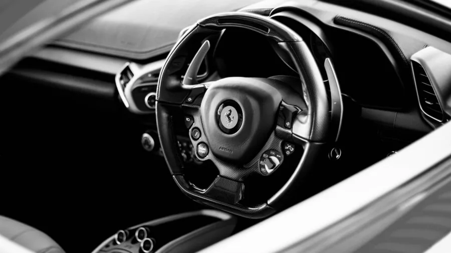 Close-up of black leather car interior showing dashboard and seat textures
