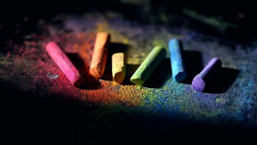 Close-up of climber's hands with white chalk powder during indoor rock climbing workout session