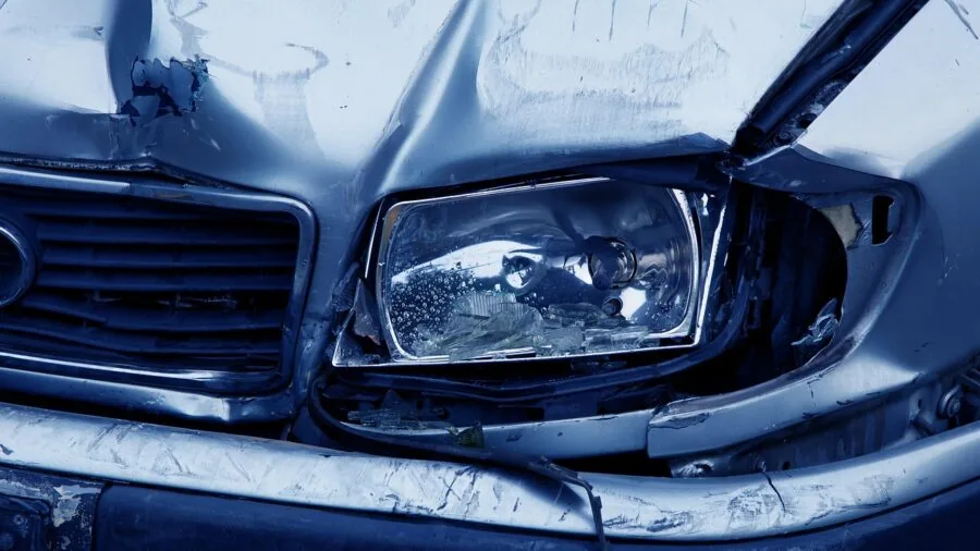 Close-up of cloudy oxidized car headlight during daytime inspection