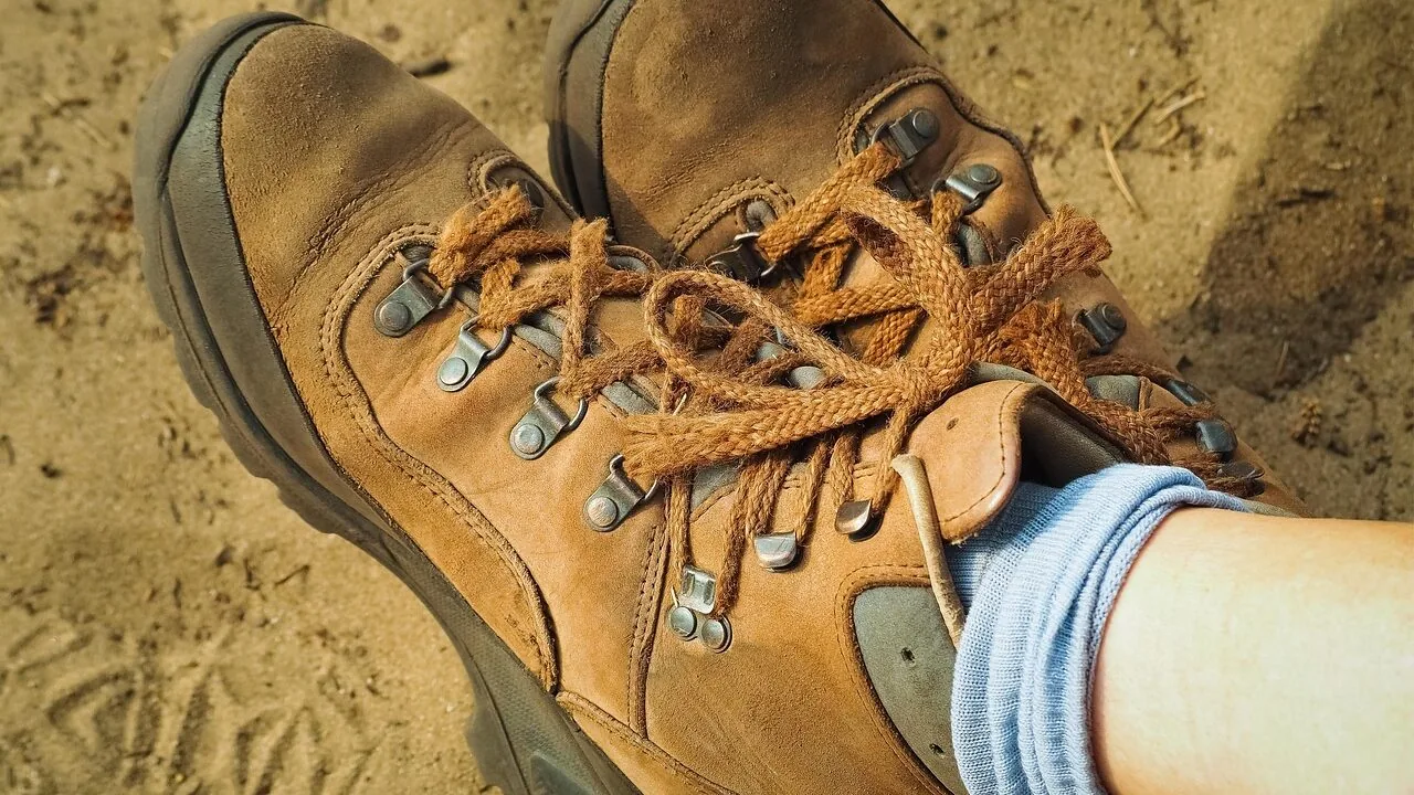 Close-up of colorful hiking socks displayed outdoors with mountain scenery background