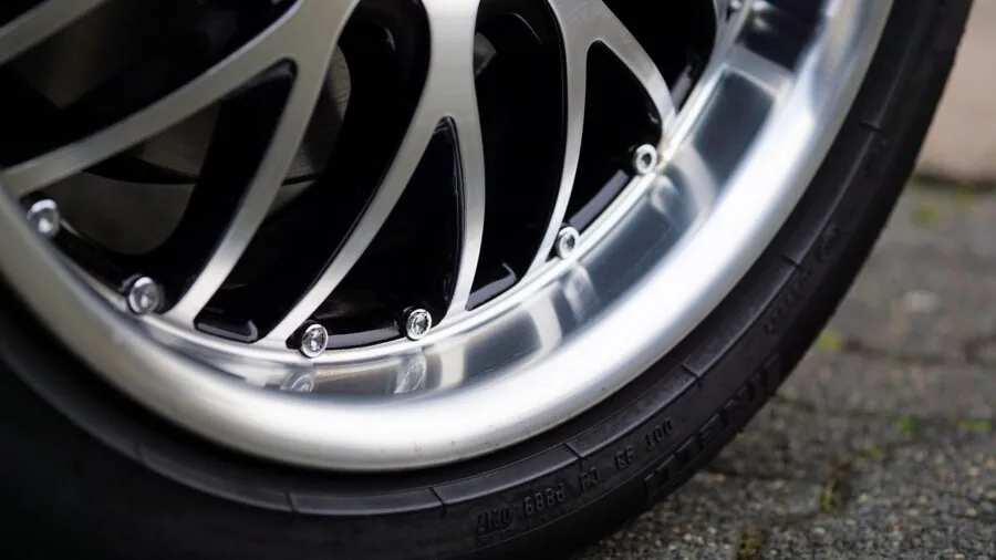 Close-up of durable rubber wheel chock securing an RV tire during outdoor camping