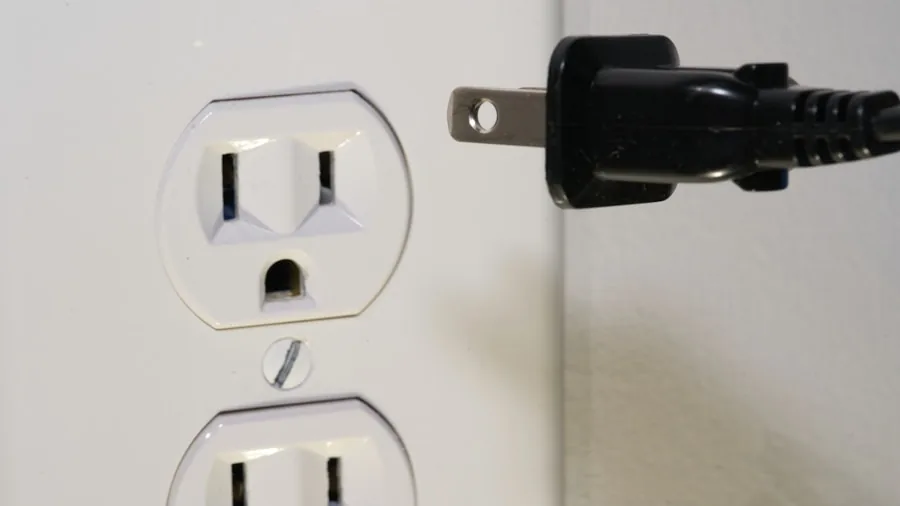 Close-up of electrical outlet being installed in white wall during home renovation project