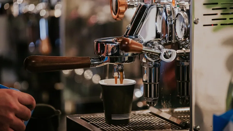 Close-up of espresso extraction with water flowing through coffee grounds in portafilter