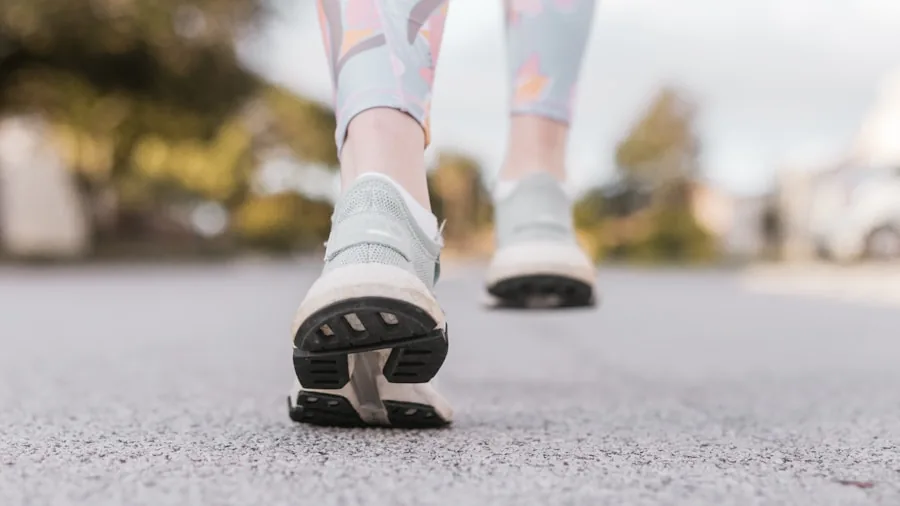 Close-up of female runner's feet and legs during outdoor running stride on pavement