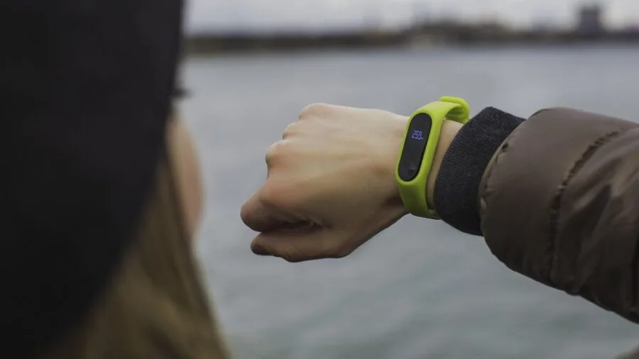 Close-up of fitness watch and smartphone showing workout metrics during exercise session