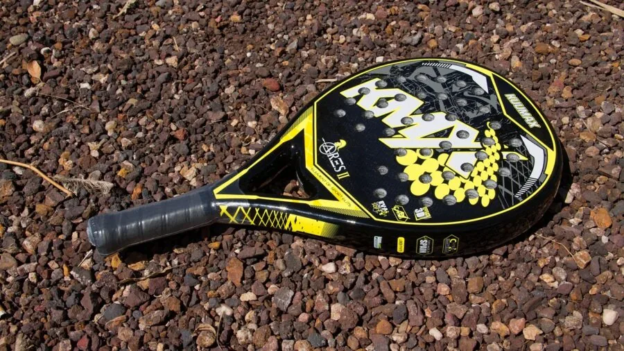 Close-up of gardener inspecting metal shovel blade in natural daylight