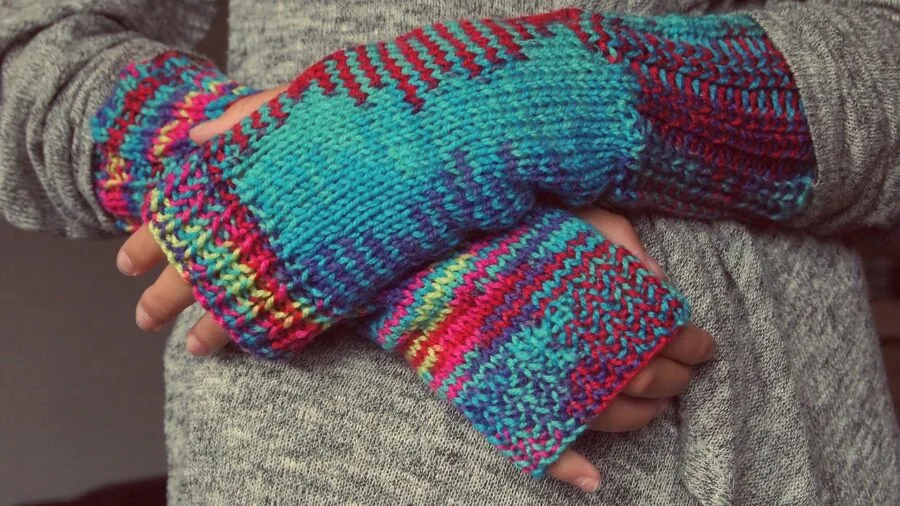 Close-up of hands adjusting properly fitting winter gloves outdoors in cold weather