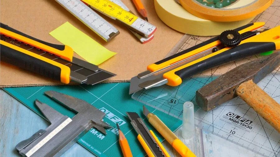Close-up of hands applying adhesive tape to smartphone back, showing careful grip installation process