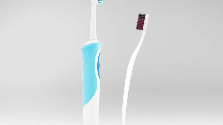 Close-up of hands checking toothbrush head compatibility and fit with handle