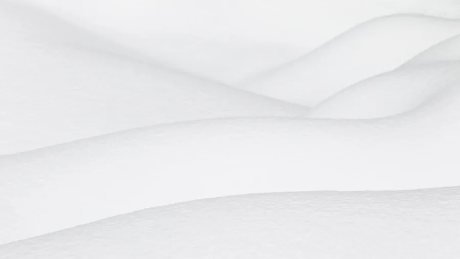 Close-up of hands feeling soft white bed sheets, examining fabric quality and texture