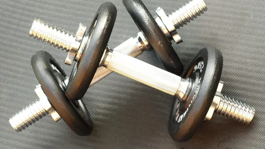 Close-up of hands gripping barbell during weightlifting workout at gym