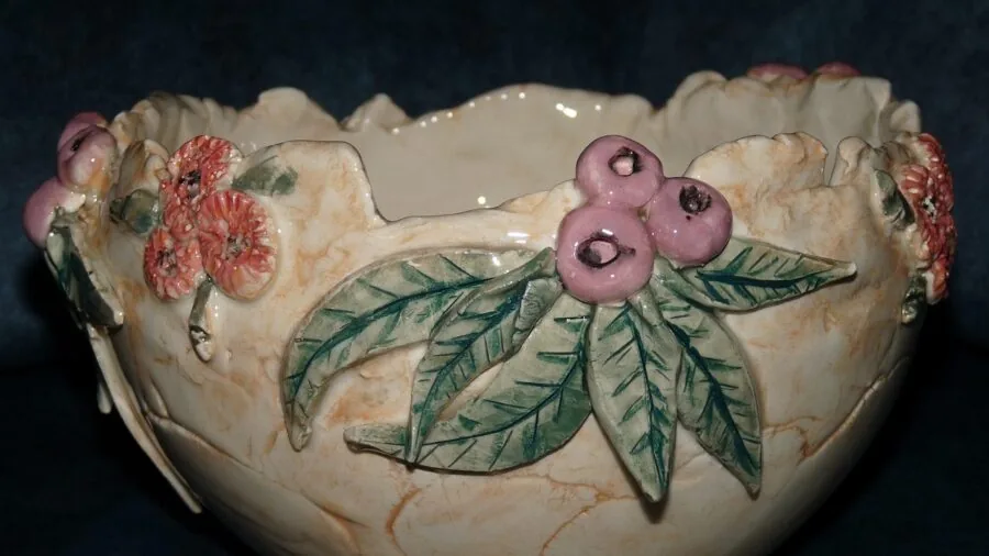Close-up of hands holding a ceramic bowl in a bright kitchen setting