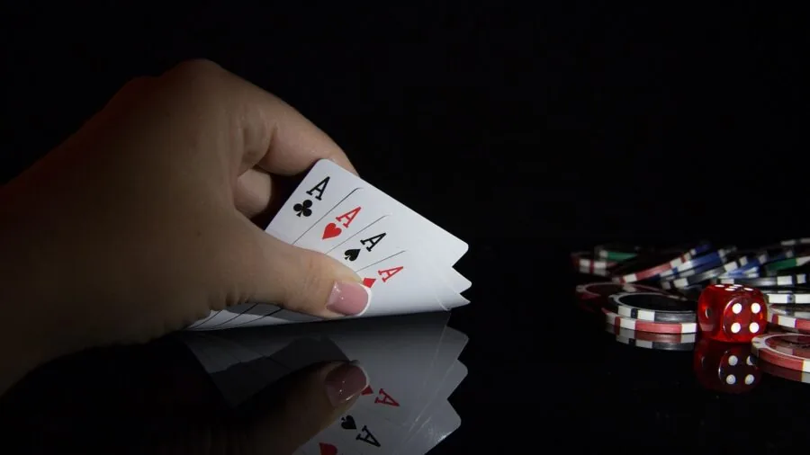 Close-up of hands holding and playing with poker chips during a casual game