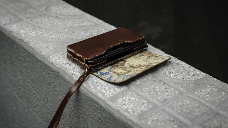 Close-up of hands holding quality leather wallet showing material texture and craftsmanship