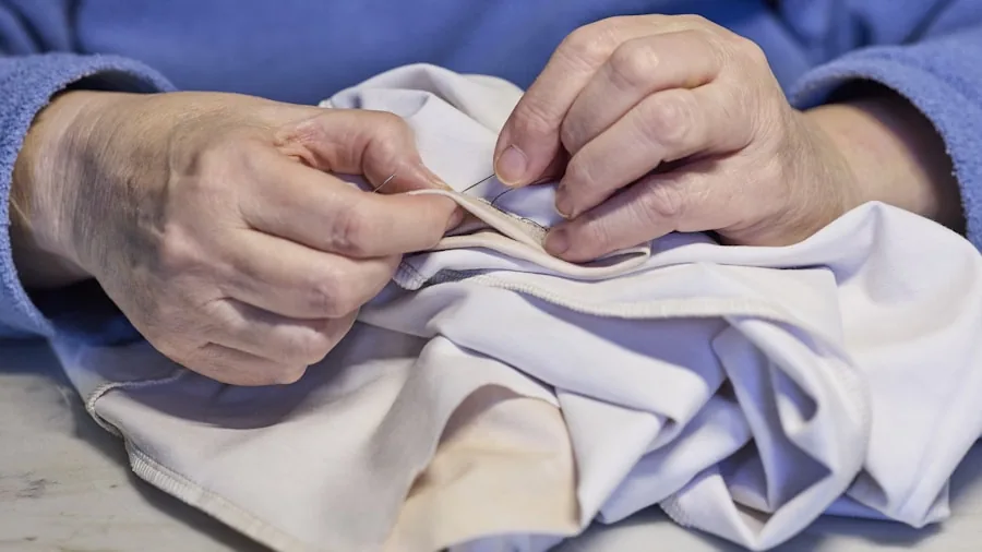 Close-up of hands inspecting different fabric materials and textures for durability and quality
