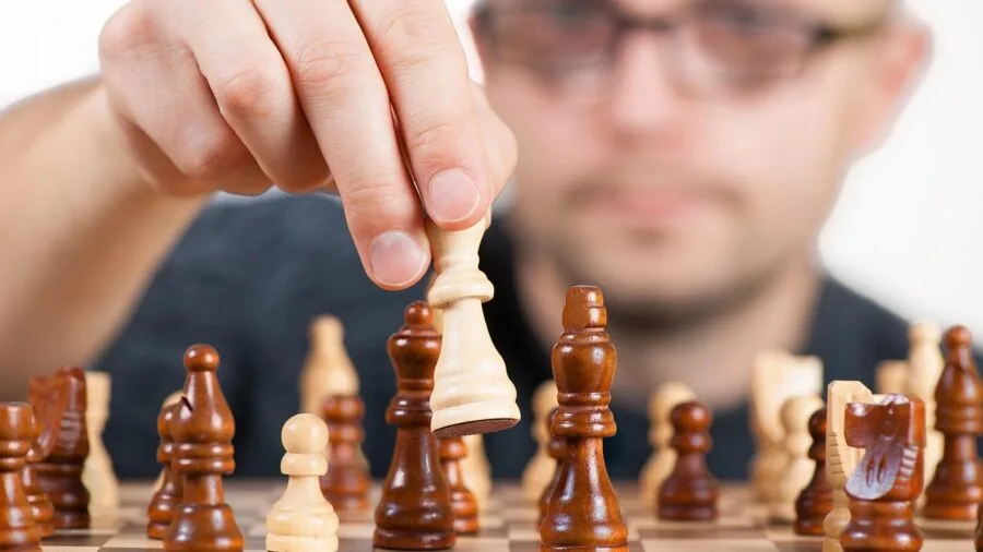 Close-up of hands inspecting game pieces and cards for quality during gameplay