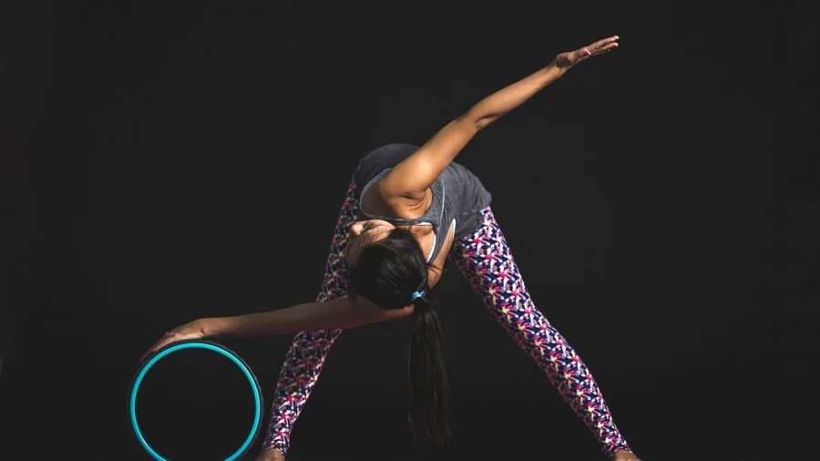Close-up of hands measuring yoga mat thickness and density during purchase consideration