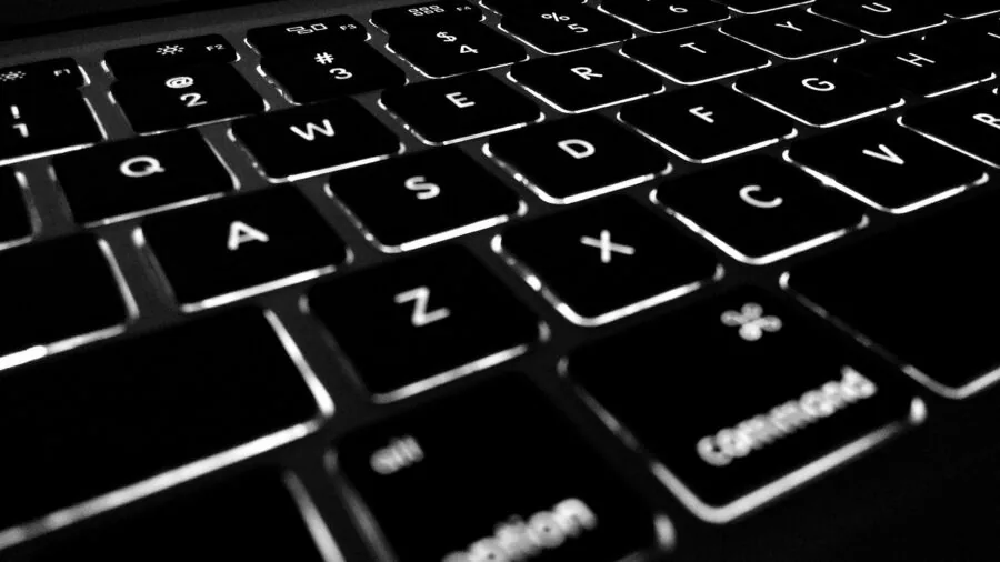Close-up of hands typing on a mechanical keyboard with visible switch mechanisms during gaming session