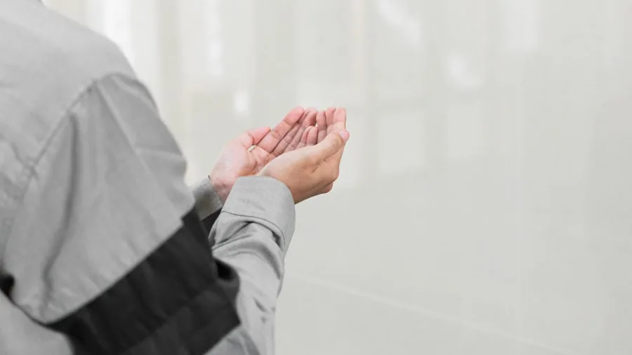 Close-up of hands wearing protective work gloves during construction or industrial task