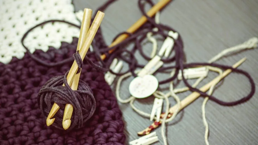 Close-up of hands working with crochet hook and yarn during an active crafting session