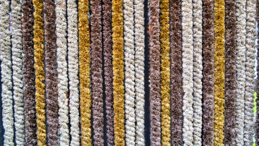 Close-up of high-quality wool blazer fabric showing natural drape and weave texture on a man