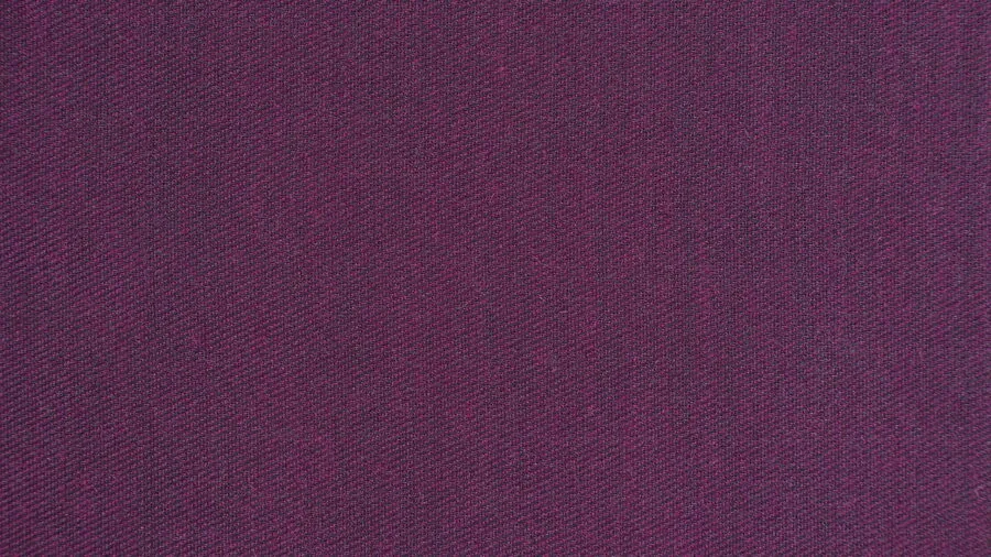 Close-up of high-quality wool suit fabric texture and drape on a man in natural lighting