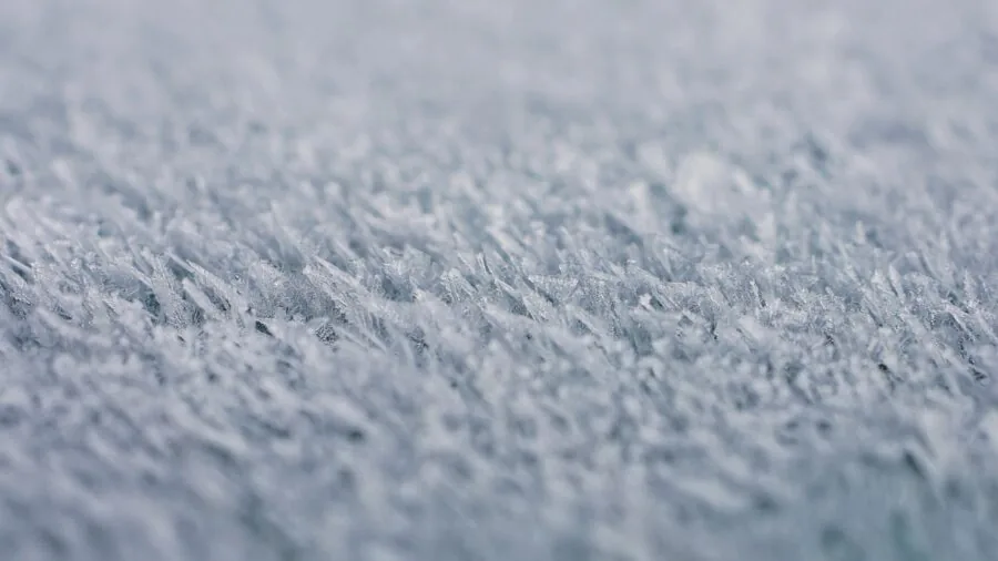 Close-up of ice skate blade on frozen ice during winter skating session