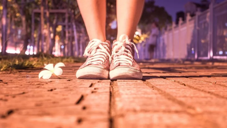 Close-up of male runner's feet hitting pavement during outdoor running session