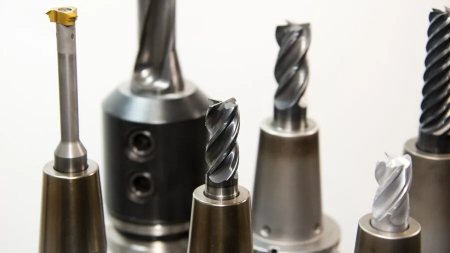 Close-up of metal surfaces being joined together with strong adhesive in a workshop setting