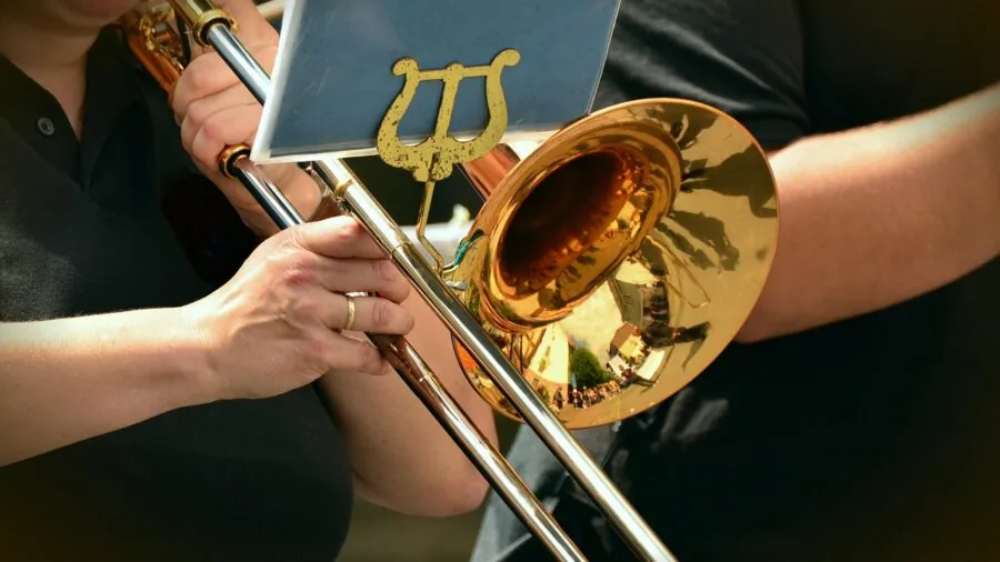 Close-up of musician playing trumpet, focusing on the bell and sound production during performance