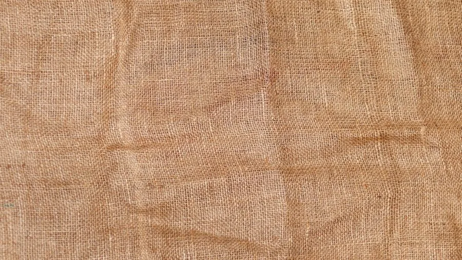 Close-up of natural canvas fabric texture and weave pattern in neutral tones