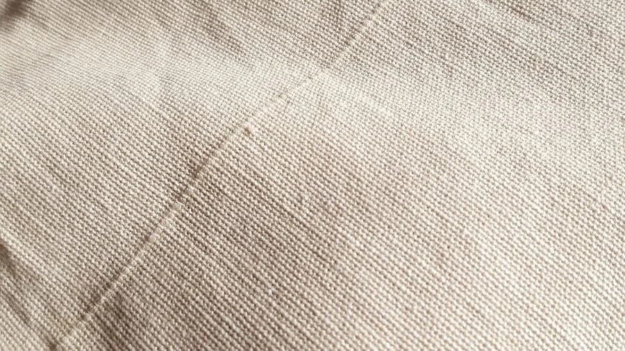 Close-up of natural cotton fabric texture showing weave and breathable material quality