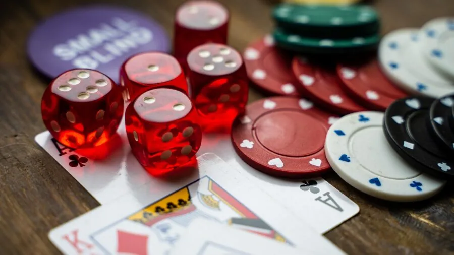 Close-up of playing cards fanned out on a wooden table during a casual game night with friends