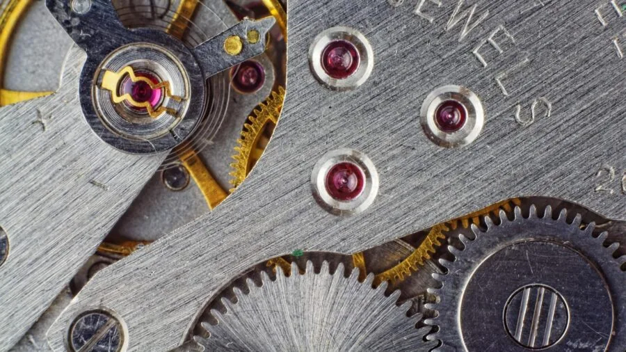 Close-up of polished metal watch case showing craftsmanship and material quality in natural light