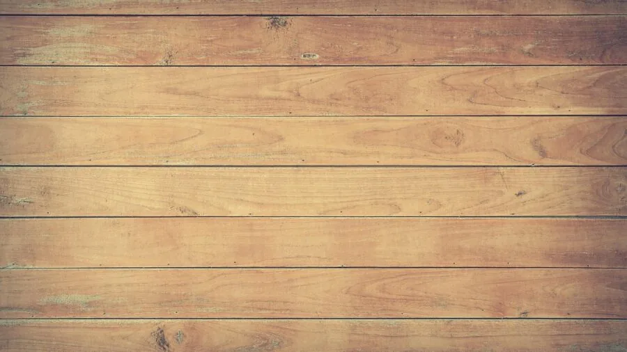 Close-up of polished wood veneer surface showing grain detail and reflective finish