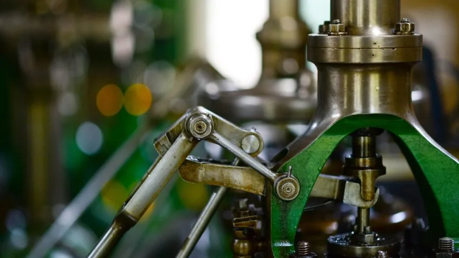 Close-up of precision metalworking in industrial workshop with cutting fluid application