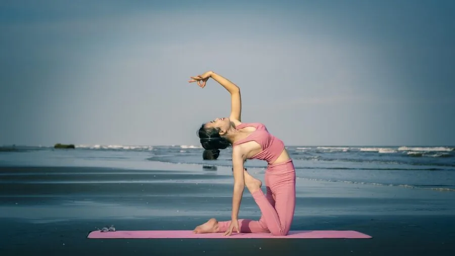 Close-up of rolled yoga mat showing padding thickness and texture for travel practice