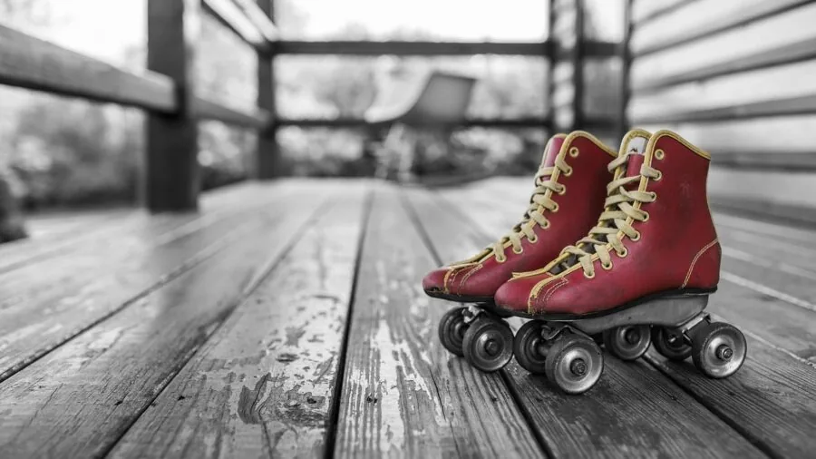 Close-up of roller skate undercarriage showing wheels and metal plate system