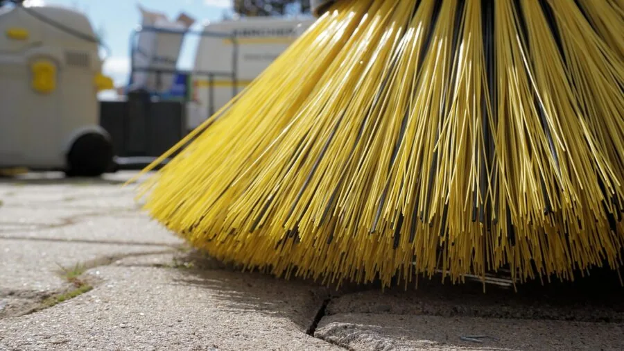Close-up of rotating brush bristles actively scrubbing carpet fibers during cleaning process