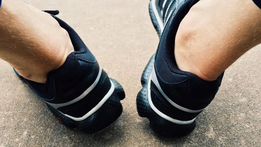 Close-up of runner's feet in motion on pavement during outdoor training session