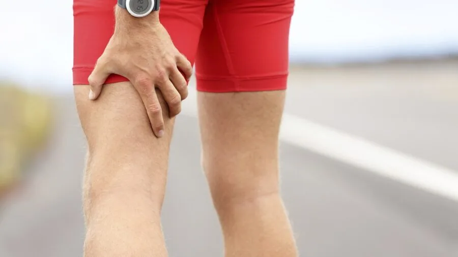 Close-up of runner's legs in compression tights during outdoor workout