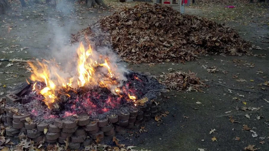 Close-up of rustic metal fire pit showing rust and patina from outdoor weather exposure