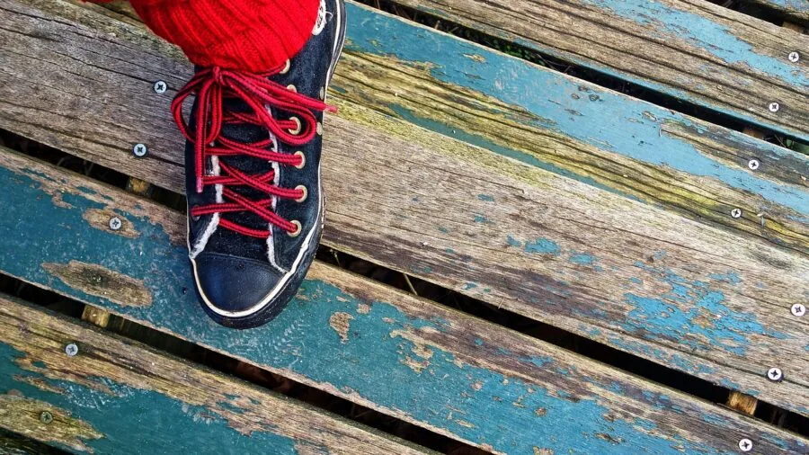 Close-up of skier adjusting cushioned socks before putting on ski boots outdoors