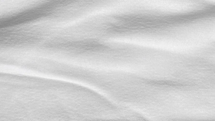 Close-up of smooth, wrinkle-free fabric surface with even lighting showing pristine textile quality