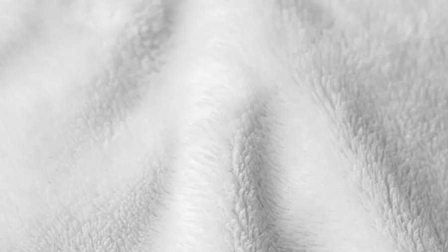 Close-up of soft flannel and sherpa fabric textures showing comfort and warmth