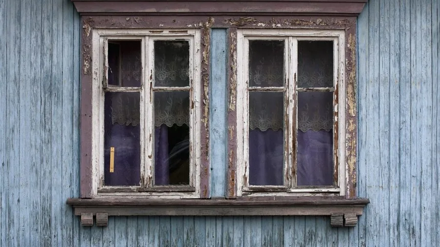 Close-up of solid wooden window frame showing structural support and durability in natural daylight
