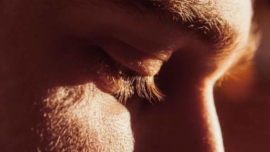 Close-up of someone applying exfoliating scrub to their skin during a skincare routine